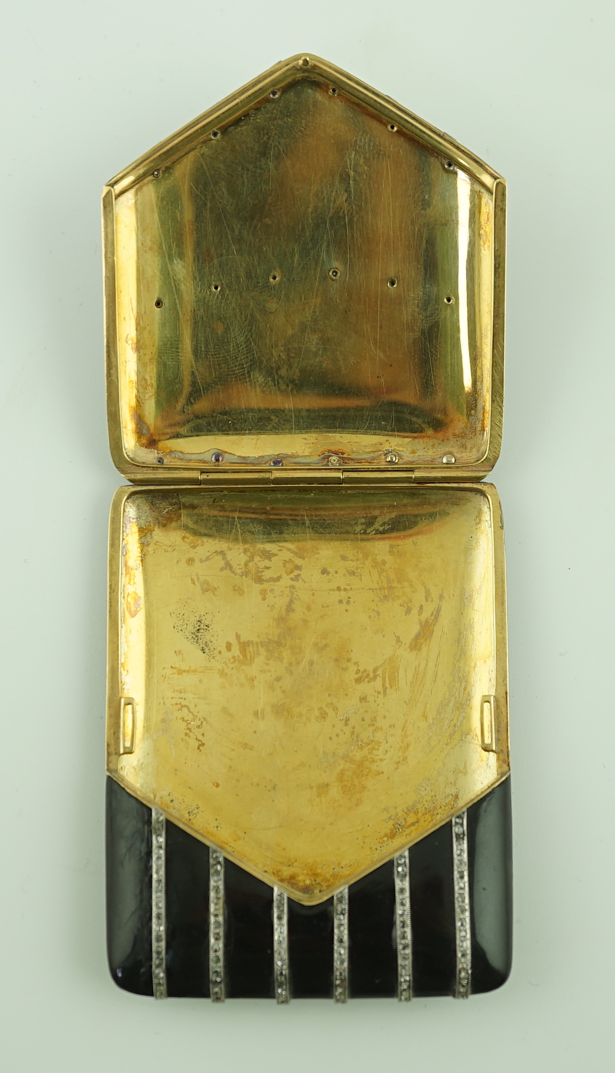 A 1920's gold and black enamel cigarette case, set with six rows of millegrain set rose cut diamonds